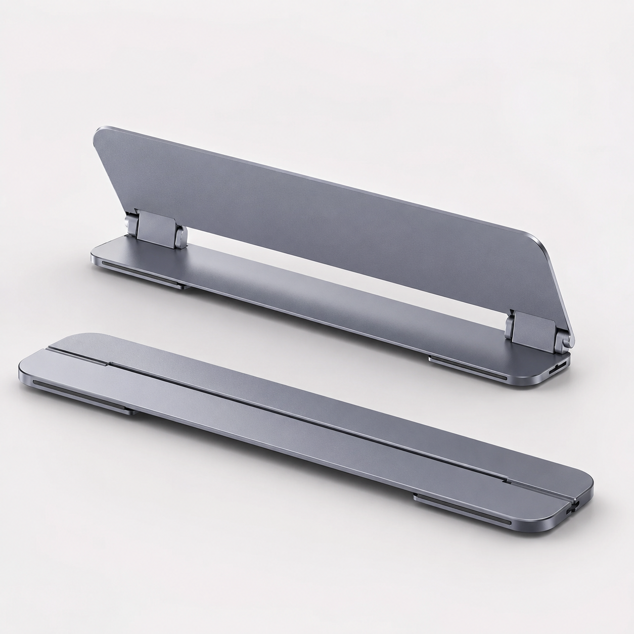 Space Grey fold-out laptop stand shown folded flat and opened in a clean product hero image